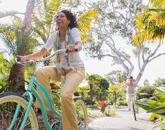 Happy Mature woman riding a bike
